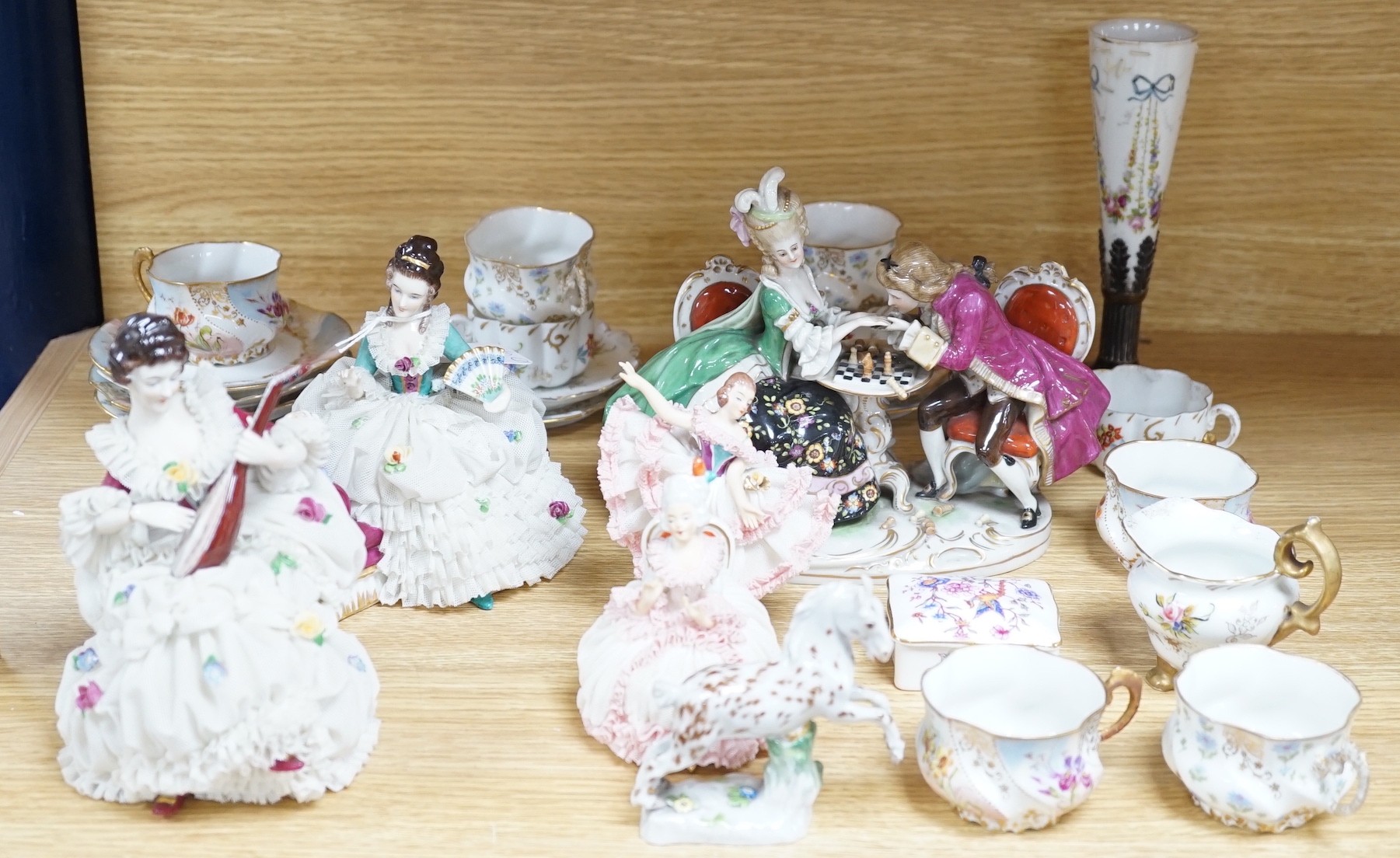 A group of Continental porcelain cabinet cups and saucers, a vase, crinoline figures and a Meissen horse, horse 9 cms high